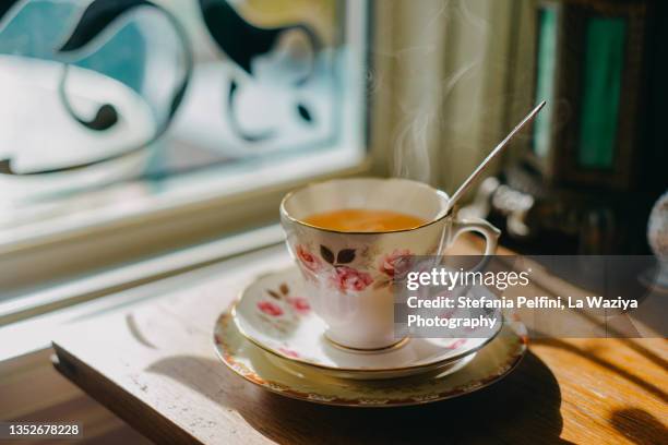 tea cup steaming - vintage crockery stock pictures, royalty-free photos & images