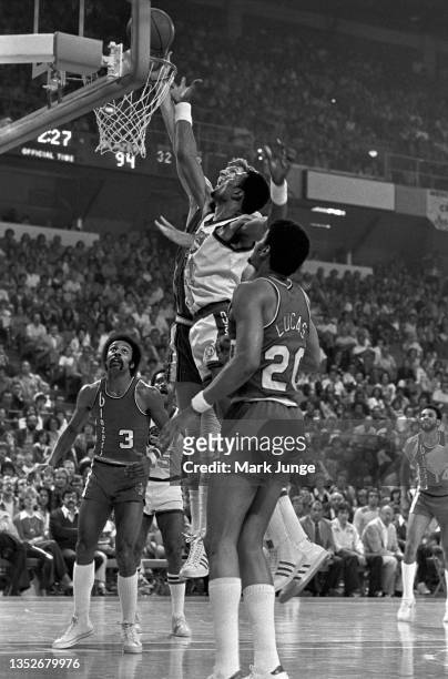 Denver Nuggets center Marvin Webster attempts to block a layup by Portland Trail Blazers center Bill Walton during an NBA playoff game at McNichols...