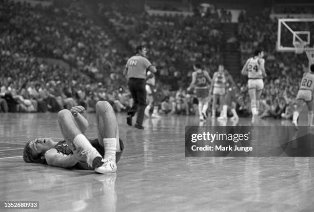 Portland Trail Blazers guard Dave Twardzik lies in pain on the court with an ankle injury sustained in an NBA playoff game against the Denver Nuggets...