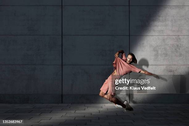 male ballet dancer balancing on toes - urban ballet stockfoto's en -beelden