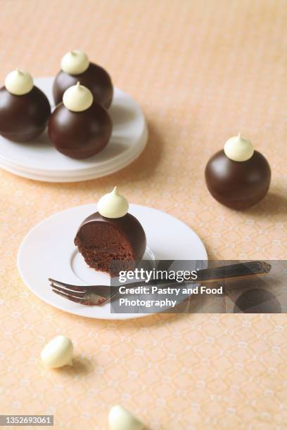 chocolate glazed cake pops without stick - dried plum stock pictures, royalty-free photos & images