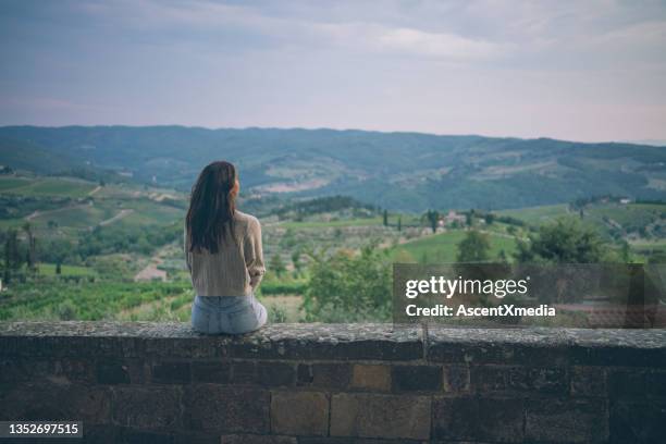 young woman sit wall - sitting on a cloud stock pictures, royalty-free photos & images