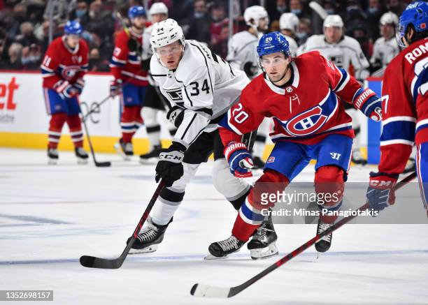 Arthur Kaliyev of the Los Angeles Kings and Chris Wideman of the Montreal Canadiens skate against each other during the third period at Centre Bell...