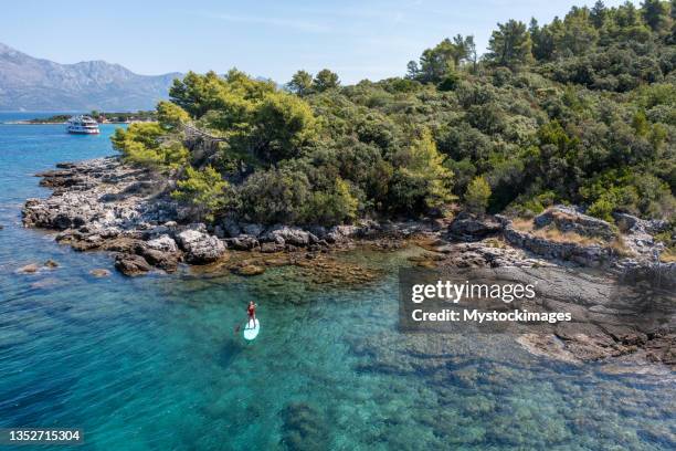 aerial view of woman on a stand up paddle - hvar stockfoto's en -beelden