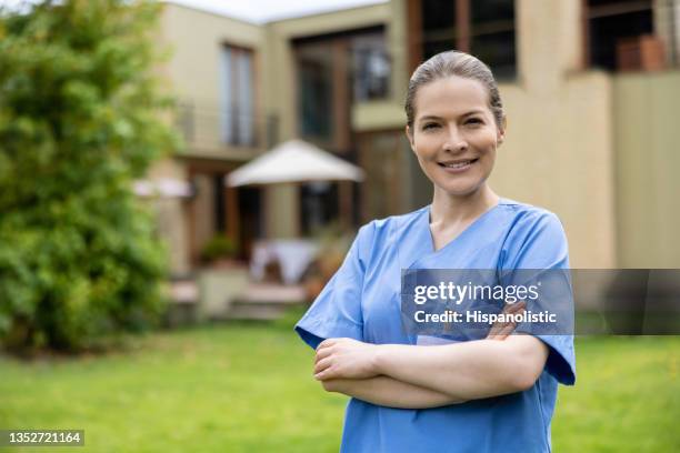 happy home caregiver outside a house â assisted living - nursing assistant stock pictures, royalty-free photos & images