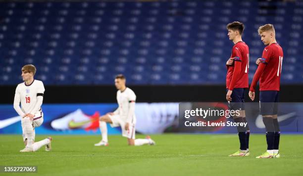 Tomáš Čvančara and Adam Karabec of Czech point to a respect logo as England players take a knee before kick off during the UEFA European Under-21...