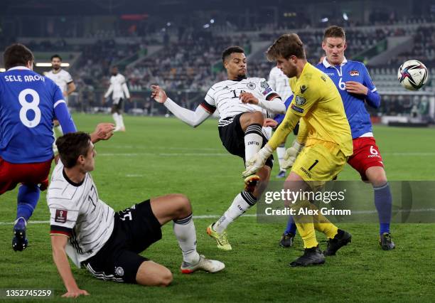 Lukas Nmecha of Germany challenges Benjamin Büchel, goalkeeper of Liechtenstein during the 2022 FIFA World Cup Qualifier match between Germany and...