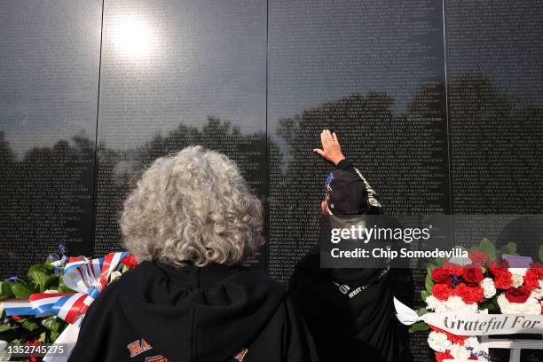 Jennifer and Robert Lawrence of Leonard, Michigan, look at the place on the Vietnam Veterans Memorial wall where Robert's brother Richard Lawrence's...