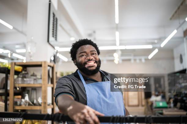portrait of a salesman organizing products at a decoration store - vitiligo stock pictures, royalty-free photos & images
