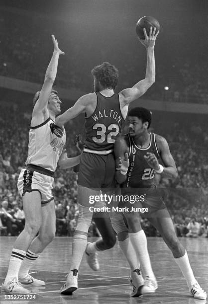 Portland Trail Blazers center Bill Walton holds the ball away from center Dan Issel during an NBA playoff game against the Denver Nuggets at...