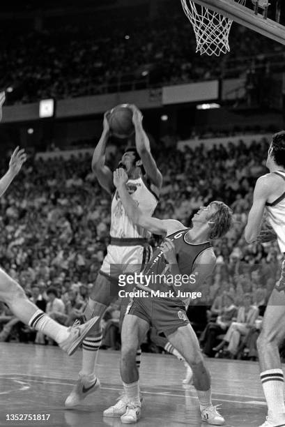Denver Nuggets forward Willie Wise grabs a rebound over guard Dave Twardzik during an NBA playoff game against the Portland Trail Blazers at...