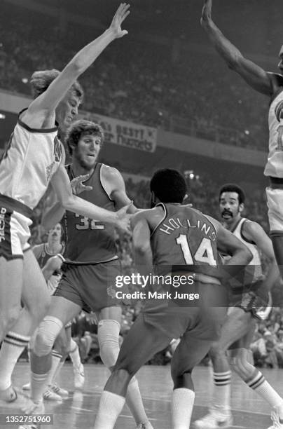Denver Nuggets center Dan Issel attempts to block guard Lionel Hollins from his path to the basket during an NBA playoff game against the Portland...