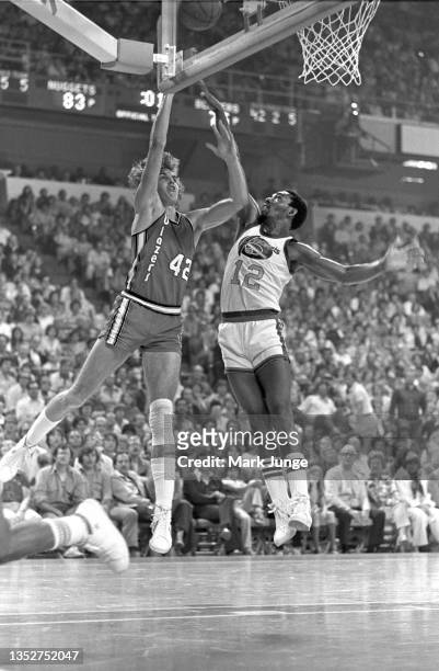Portland Trail Blazers forward Wally Walker attempts a layup over guard Ted McClain during an NBA playoff game against the Denver Nuggets at...