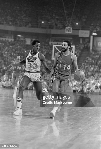 Portland Trail Blazers point guard Lionel Hollins tries to drive past forward David Thompson during an NBA playoff game against the Denver Nuggets at...