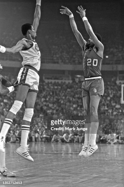 Portland Trail Blazers forward Maurice Lucas takes a jump shot over center Marvin Webster during an NBA playoff game against the Denver Nuggets at...