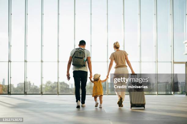 unrecognizable family having fun traveling together - family airport stock pictures, royalty-free photos & images