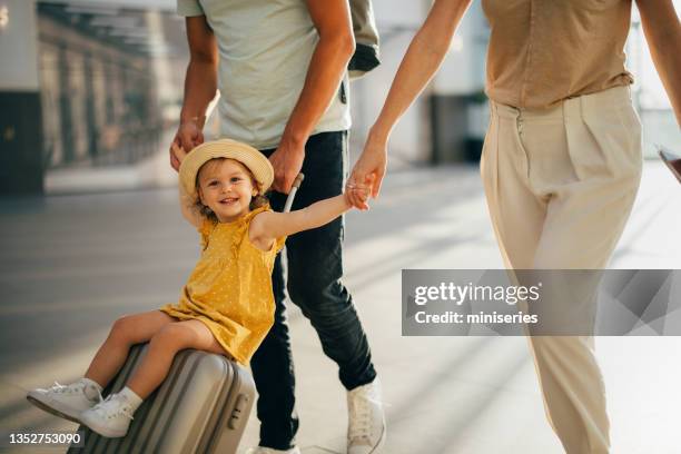 young family having fun traveling together - airport sitting family stock pictures, royalty-free photos & images