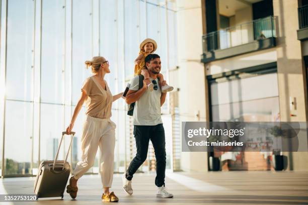 excited family going on vacation together - airport departure area stockfoto's en -beelden