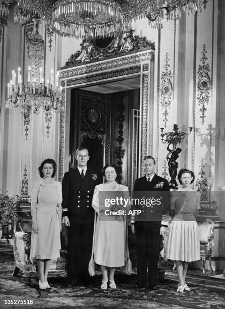 Princess Elizabeth , Philip Mountbatten , Queen Elizabeth , King George VI and Princess Margaret pose in the Buckingham Palace on July 09, 1947 in...