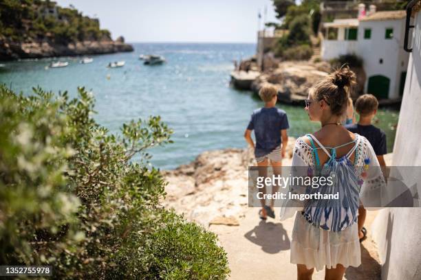 family walking on a path on cliffs at the beautiful cove - white bay stock pictures, royalty-free photos & images