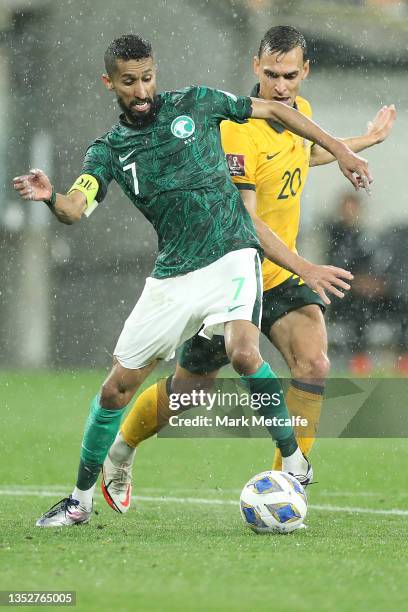 Salman Alfaraj of Saudi Arabia is challenged by Trent Sainsbury of Australia during the FIFA World Cup AFC Asian Qualifier match between the...