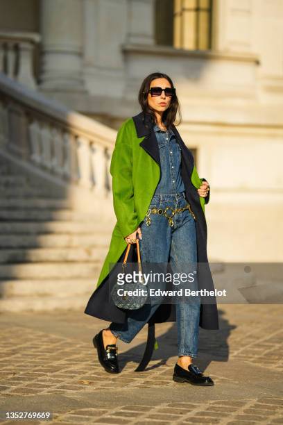 Gabriella Berdugo wears a blue denim shirt from Wrangler, matching blue denim jeans pants from Wrangler, a vintage golden chain belt, black leather...