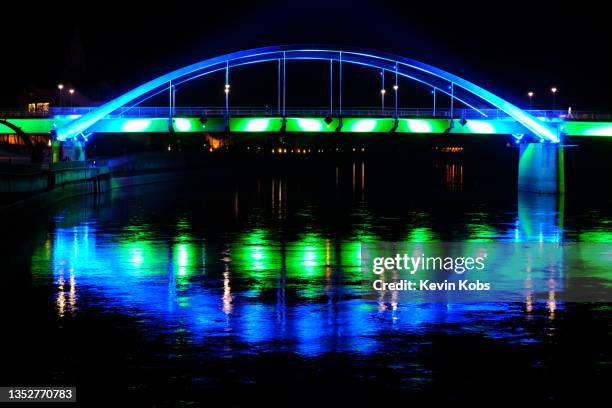 view of newly lit city bridge in frankfurt (oder) / słubice. - under bridge night stock pictures, royalty-free photos & images