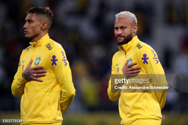 Raphinha and Neymar Jr. Of Brazil line up for the national anthem prior to a match between Brazil and Colombia as part of FIFA World Cup Qatar 2022...