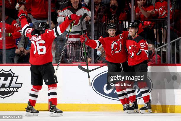 Janne Kuokkanen of the New Jersey Devils is congratulated by teammates Nico Hischier and P.K. Subban after he scored a short handed goal in the first...