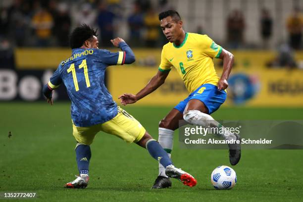 Alex Sandro of Brazil fights for the ball with Juan Cuadrado of Colombia during a match between Brazil and Colombia as part of FIFA World Cup Qatar...