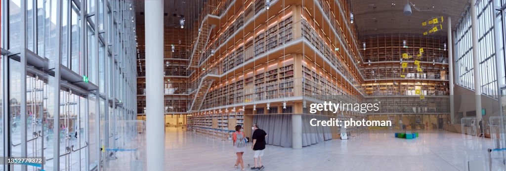 Indoor panoramic view of the new library with walking couple