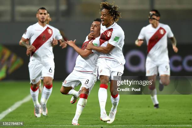 Christian Cueva of Peru celebrates with teammate André Carrillo after scoring the second goal of his team during a match between Peru and Bolivia as...