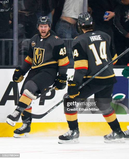 Paul Cotter and Nicolas Hague of the Vegas Golden Knights celebrate after Hague assisted Cotter on his first NHL goal in the first period of a game...