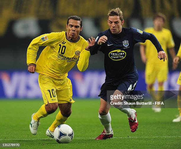 Leandro Domingues of Kashiwa Reysol is tackled by Dave Mulligan of Auckland City during the FIFA Club World Cup match between Kashiwa Reysol and...