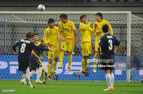 Dave Mulligan of Auckland City curls the ball over the Kashiwa Reysol wall during the FIFA Club World Cup match between Kashiwa Reysol and Auckland...