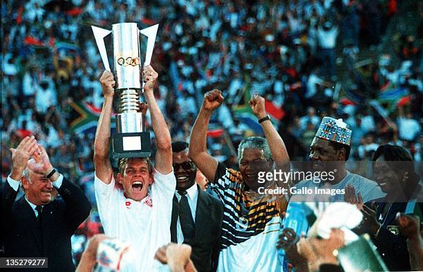 Neil Tovey of South Africa, captain of the winners of the African Cup of Nations Final celebrates with the trophy after President Nelson Mandela...