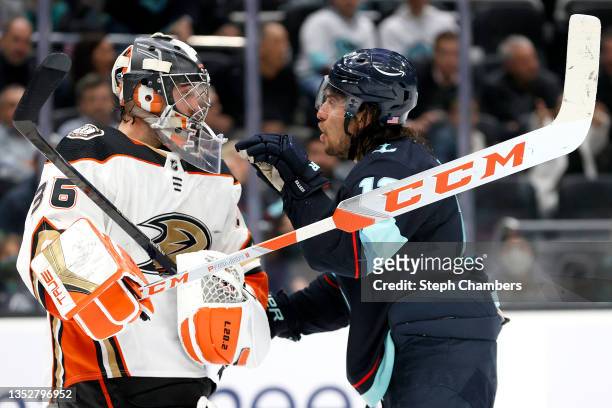 John Gibson of the Anaheim Ducks and Brandon Tanev of the Seattle Kraken exchange words during the second period on November 11, 2021 at Climate...