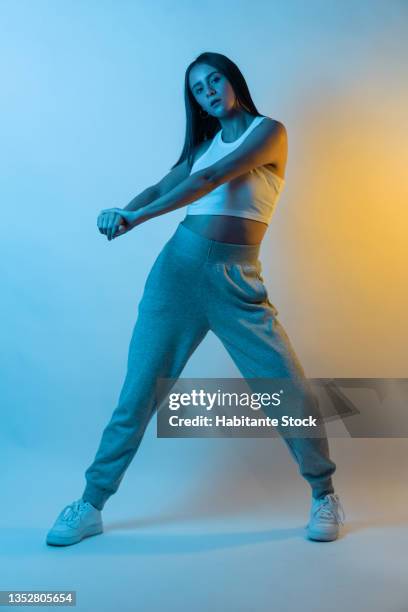 woman in sportswear dancing on a blue and yellow background, studio session - mexico training session stock pictures, royalty-free photos & images