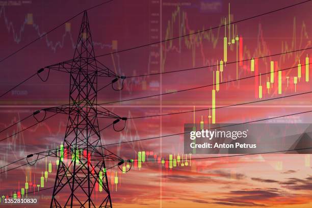 high voltage towers on the background of stock charts. electricity price change concept - konsumerism bildbanksfoton och bilder