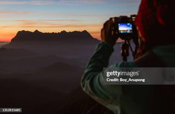 cropped shot of photographer taking beautiful view of doi luang chiang dao mountain in chiang mai province of thailand at dawn. - chiang mai province stock-fotos und bilder