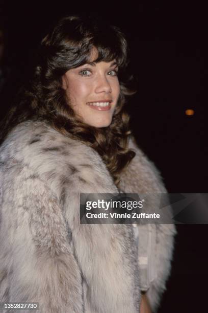 American singer and actress Barbi Benton wearing a fur coat, circa 1985.