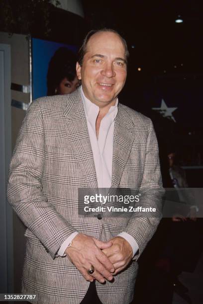American former professional baseball player Johnny Bench, in a grey jacket over a white shirt, attends the National Association of Television...