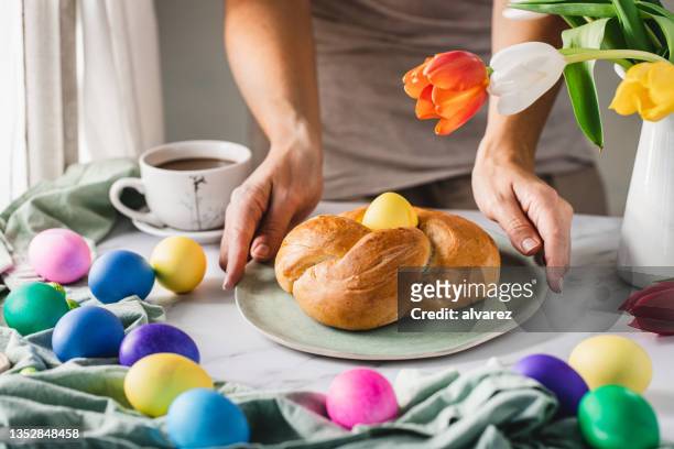 close-up of woman serving breakfast for easter - paasontbijt stockfoto's en -beelden