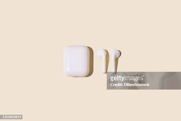 wireless white headphones on yellow pastel background. - apple fruit white background stock pictures, royalty-free photos & images