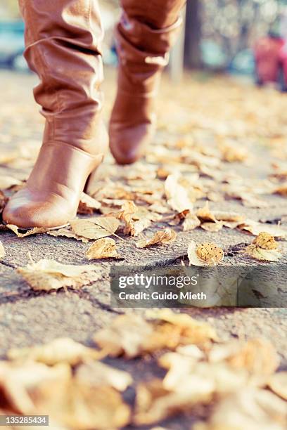 close up of woman with boots - legs walking stock-fotos und bilder