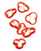 Falling sweet pepper slices, paprika, isolated on white background, clipping path, full depth of field