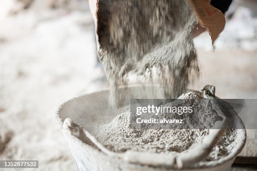Filling a bucket with cement at construstion site Filling a bucket with cement at construstion site