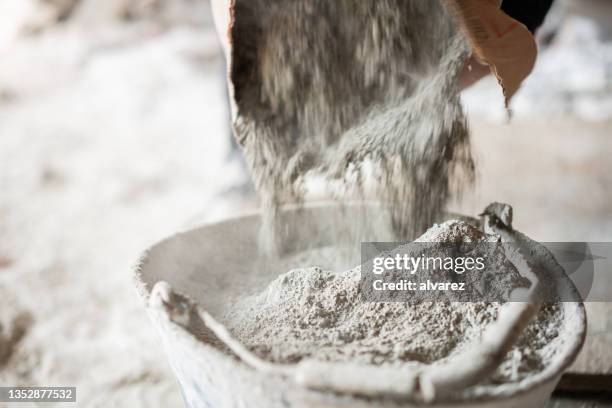 filling a bucket with cement at construstion site - cement stock pictures, royalty-free photos & images