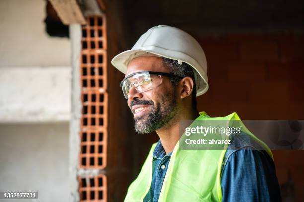 african man working at construction site - african american man day dreaming stock pictures, royalty-free photos & images