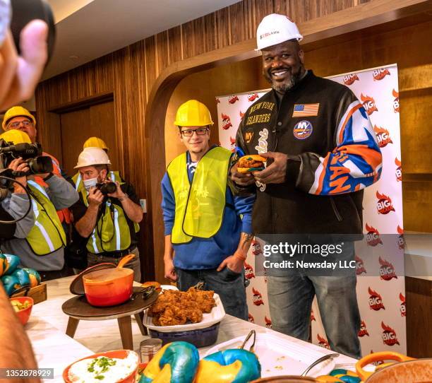 Former NBA champion Shaquille O'Neal holding a Big Chicken sandwich that will be sold at his restaurant during a tour of the UBS Arena in Elmont, New...